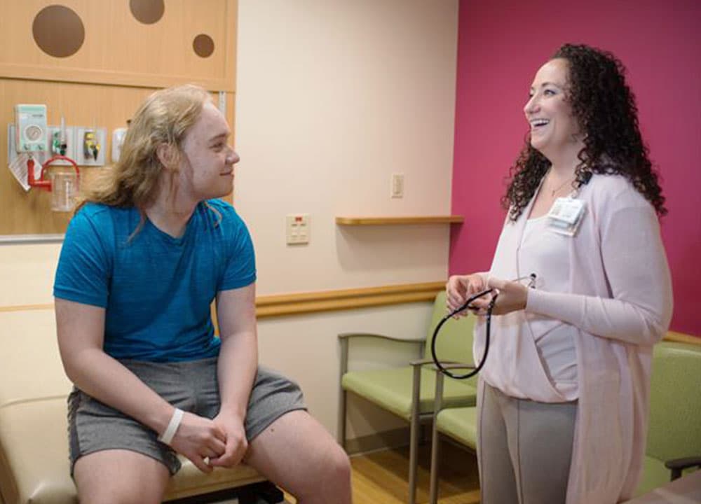 Dr. Malec and a patient at the adult hematology center.