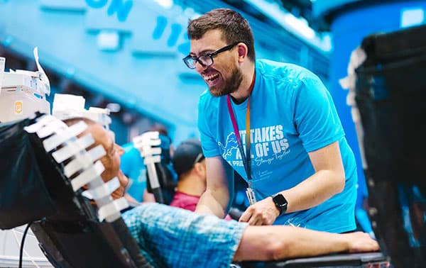 Phlebotomist smiling and talking to a donor at a One Pride Blood Drive.