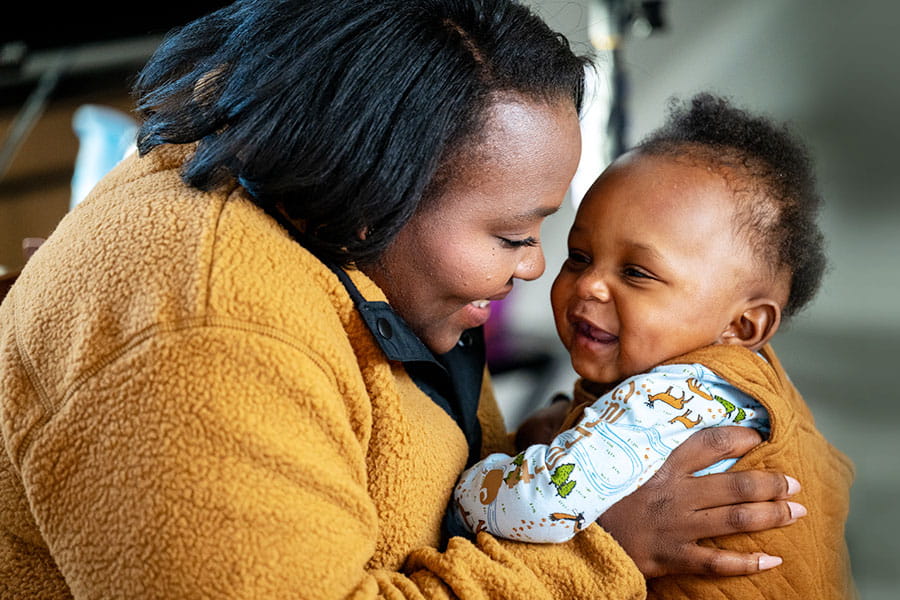 Divinity, holding her smiling son.