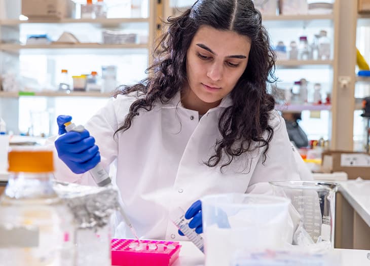 A researcher pipetting some tests.