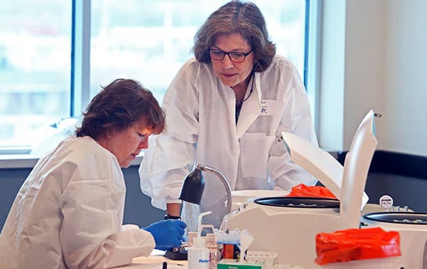 Sue talking with a training attendee.